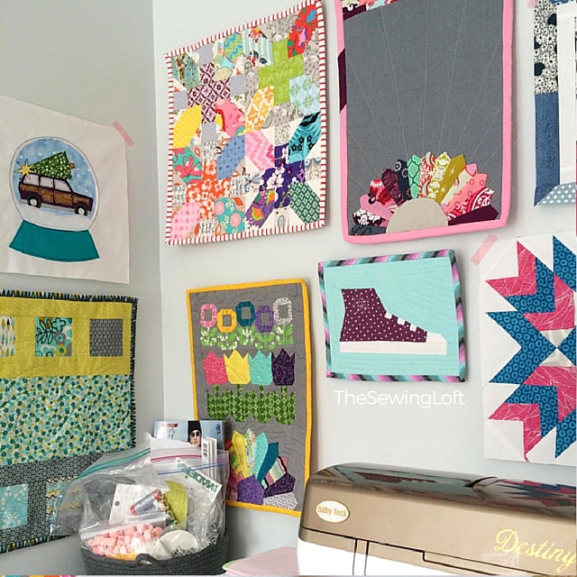 Sewing Corner of The Sewing Loft. Love the way the wall of mini quilts is coming together.