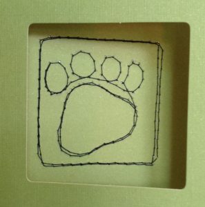 Create a pet sympathy card with a stitched paw print 