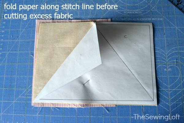 Do not cut through paper template. Instead, fold template back along stitch line before cutting away excess fabric. 