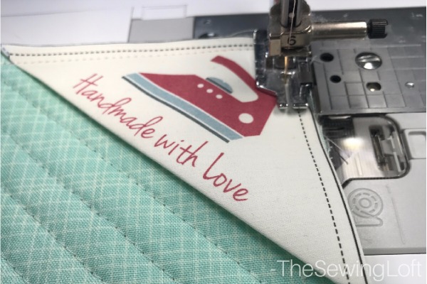 Don't forget to add a label to your sewing project before attaching the quilt binding. 