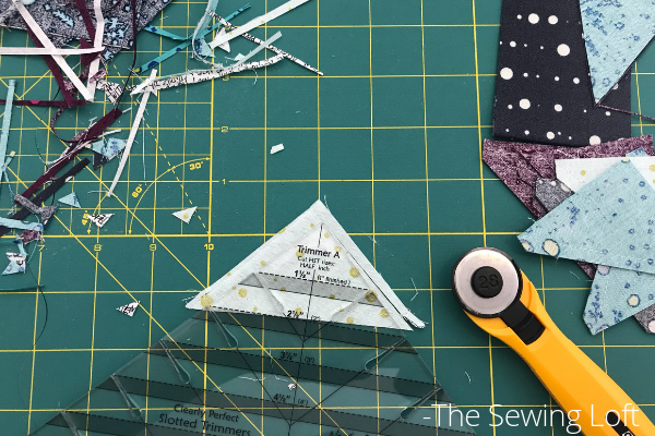 Cutting half square triangles is a breeze with the Clearly Perfect Slotted Ruler. 
