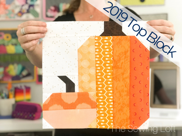 The simple patchwork construction of the Pretty Pumpkins quilt block makes it perfect for for quilters to play with their scraps. 