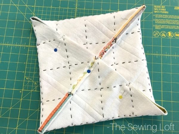 Learn how easy it is to create an on point patchwork pillow with the help of origami. 