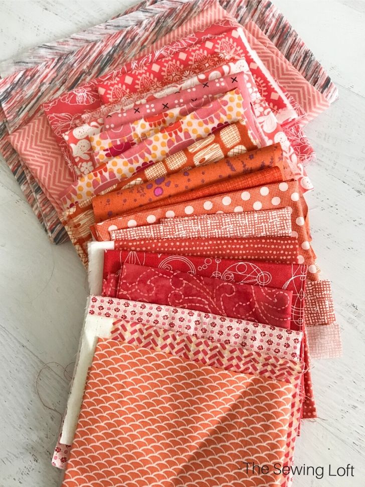 Assortment of orange fabrics to make my Poppy Seed quilt top. 
